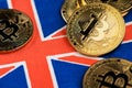 Bitcoin BTC Cryptocurrency coins on UK flag. Brexit concept