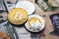 Bitcoin, Ethereum, Monero coins on Chinese Yuan and US dollars banknotes