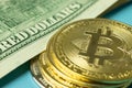 Bitcoin BTC gold coin and money on background. Macro photo. American dollars