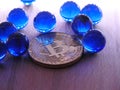 Bitcoin with blue glass marbles. Royalty Free Stock Photo