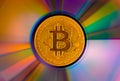 Bitcoin coin on a CD - DVD, background for design Royalty Free Stock Photo