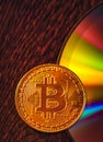 Bitcoin coin on a CD - DVD, background for design Royalty Free Stock Photo