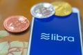 Bitcoin Coin with the Facebook`s Libra Crypto Coin logo