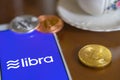 Bitcoin Coin with the Facebook`s Libra Crypto Coin logo