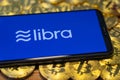 Bitcoin Coin with the Facebook`s Libra Crypto Coin logo