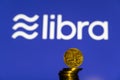 Bitcoin Coin with the Facebook`s Libra Crypto Coin logo