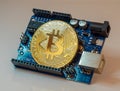 Bitcoin coin on mini computer board