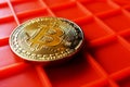 Bitcoin coin on orange background