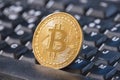 Bitcoin coin over black keyboard Royalty Free Stock Photo