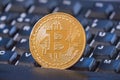 Bitcoin coin over black keyboard Royalty Free Stock Photo