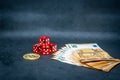 Bitcoin coin, a pile of Euro banknotes and a few red cubes lie side by side on a dark background