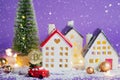 Bitcoin coin on red retro car past houses with fairy lights and snow, Christmas tree with gift boxes on roof. Violet background.