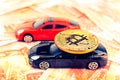 Bitcoin coin on the roof of black prestige car