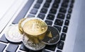 Bitcoin coin on a top of other crypto coins on a keyboard of laptop. Bitcoin golden coins. Cryptocurrency investment Royalty Free Stock Photo