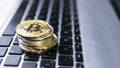 Bitcoin coin on a top of other crypto coins on a keyboard of laptop. Bitcoin golden coins. Cryptocurrency investment Royalty Free Stock Photo