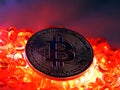 Bitcoin coin on top of red hot burning beats Royalty Free Stock Photo