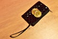 Bitcoin coin in wallet for carrying money and coins. ÃÂ¡ryptocurrency trading exchange. BTC mining and investing concept.