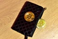 Bitcoin coin in wallet for carrying money and coins. ÃÂ¡ryptocurrency trading exchange. BTC mining and investing concept.
