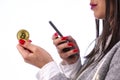Bitcoin coin in woman`s hand and smartphone Royalty Free Stock Photo