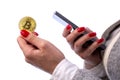 Bitcoin coin in woman`s hand and smartphone Royalty Free Stock Photo