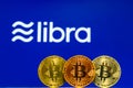 Bitcoin Coins with the Facebook Libra Crypto Coin logo