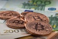 Bitcoin coins fall on euro banknotes.Crypto currency Royalty Free Stock Photo