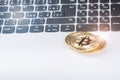 Bitcoin coins on a keyboard of white laptop. Computer. Investment situation. New virtual currency. Most valuable cryptocurrency