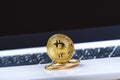 Bitcoin coins on a keyboard of white laptop. Computer. Investment situation. New virtual currency. Most valuable cryptocurrency