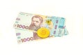 Bitcoin coins new virtual money on Ukraine banknotes close up image of bitcoins with Ukraine hryvnia banknotes. Bitcoin Royalty Free Stock Photo