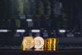 Bitcoin coins pile and two bit coins sitting in front with stock index graph chart digital background. Concept of Bitcoin