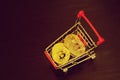 Bitcoin coins in shopping cart. Black background Royalty Free Stock Photo