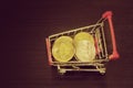 Bitcoin coins in shopping cart. Black background. Top view Royalty Free Stock Photo