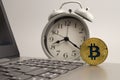 Bitcoin on the computer keyboard and alarm clock