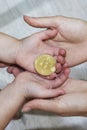 Bitcoin concept. Children share bitcoin. Child hand and bitcoin.