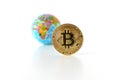 Bitcoin concept. World economy concept. New world currency.Golden coin bitcoin and globe.