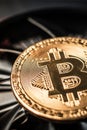 Bitcoin on cooling computer fan background Royalty Free Stock Photo