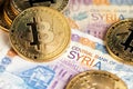 Bitcoin cryptocurrency BTC virtual money and banknotes of Syrian Pounds. Royalty Free Stock Photo