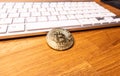 Bitcoin cryptocurrency coin on the background of the computer keyboard Royalty Free Stock Photo