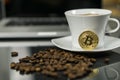 Bitcoin cryptocurrency coin with coffee cup and coffee beans