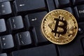 Bitcoin cryptocurrency coin on personal computer keyboard. Close up image. Crypto currency - electronic virtual money for web bank Royalty Free Stock Photo
