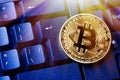 Bitcoin cryptocurrency coin on personal computer keyboard. Close up toned image. Crypto currency - electronic virtual money for we