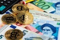 Bitcoin Cryptocurrency coins virtual money on Euro and Iranian Rial banknotes