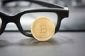 Bitcoin cryptocurrency concept.Glasses and desktop keyboard at background. stock and exchange ocupation Royalty Free Stock Photo