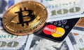 Bitcoin cryptocurrency and MasterCard cards with money, dollars Royalty Free Stock Photo