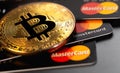 bitcoin cryptocurrency with MasterCard plastic electronic cards Royalty Free Stock Photo