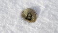 Bitcoin. Cryptocurrency on snow, in the background. The concept of freelancing, the stock exchange. Gold bitcoin on cold