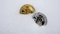 Bitcoin. Cryptocurrency on snow, in the background. The concept of freelancing, the stock exchange. Gold bitcoin on cold