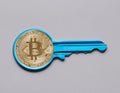 Bitcoin cryptocurrency token on key Royalty Free Stock Photo