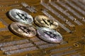 Golden silver crypto currency coin on motherboard. Shiny closeup crypto-currency coin background. Electronic money, cryptocurrency Royalty Free Stock Photo