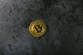 Bitcoin on dark marble. place for an inscription. gold coin bitcoin against the background of a dark stone